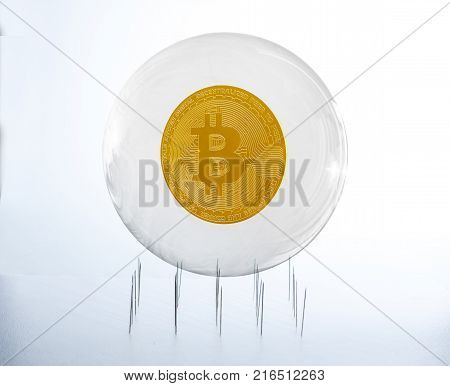 Bitcoin inside a bubble over a needles bed simulating the fragility of this speculative currency