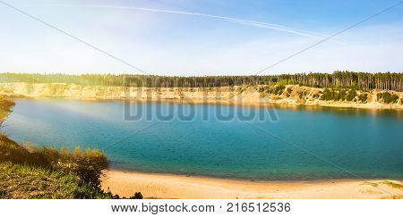 Panorama. Sunset on the river and a trail from an airplane in the sky. Toning