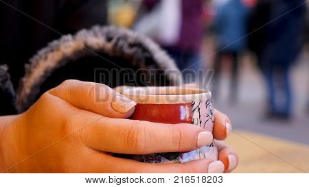 Steaming Cup of Hot Mulled Gluehwein at German Market in British Town.