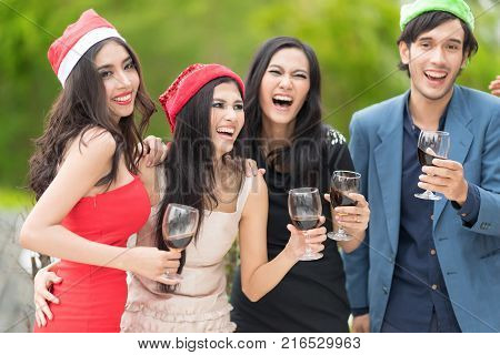 Funny People celebrating happy drinks with friends.Red wine Christmas party concept. Happy new year coming soon.Cheers.