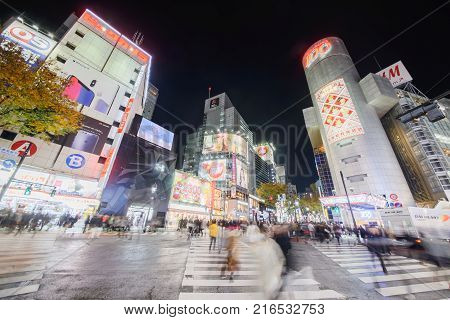 TOKYO - November 24 2017 : Shibuya District November 24 2017 in Tokyo Japan. Black Friday Night Shibuya Crossing is famous intersection located in front of the Shibuya Station