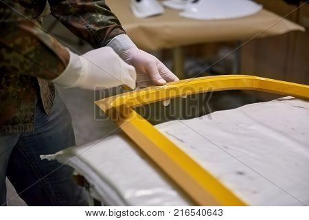 Working with a detail close-up. Working with a yellow metal detail close-up.