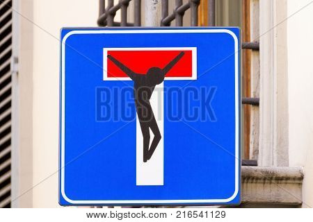 Road sign with a crucified man street art metropolitan art