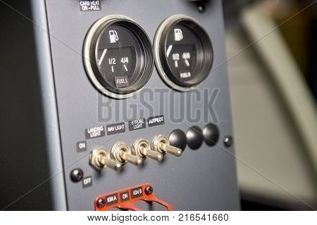 Airplane dashboard, fuel indicator. Aircraft light switches. Tips for beginner pilots.