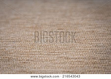 Close up of a bedge textile background. Fabric background.