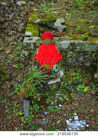 Buddha statue with praying coins on Mt. Koya in Wakayama Japan. Mount Koya (Koya-san in Japanese) is one of Japan most sacred mountains.