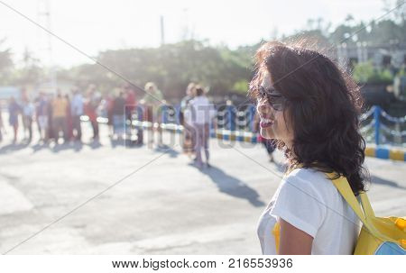 Lady Traveler staring at the queue and smiling