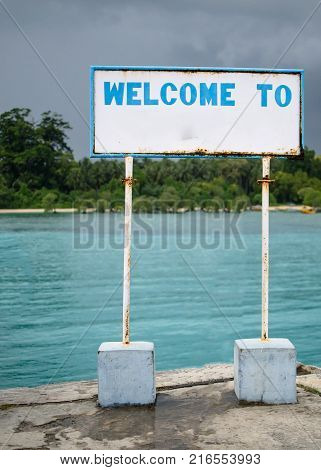 Welcome Sign Board at a Port with Blue water