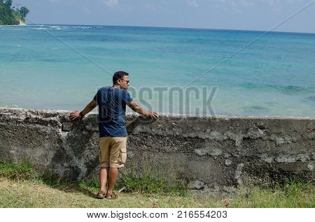 Man Standing at the beach and Looking at the sea