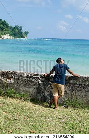 Man Standing at the beach and Looking at the sea