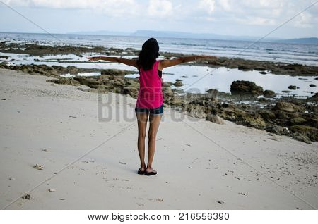 Girl With Open Arms doing Flying Gesture on a Beach