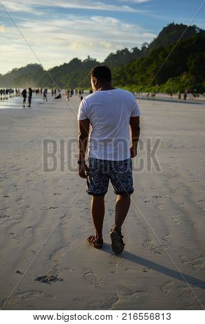 Man doing a funny walk on the beach