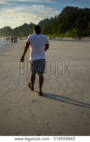 Man doing a funny walk on the beach