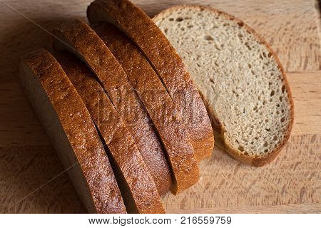 sliced rye bread on a wooden board closeup