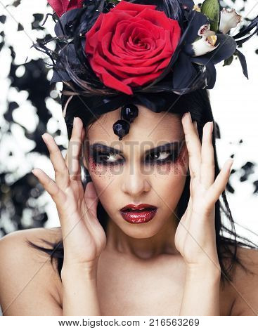 pretty brunette woman with rose jewelry, black and red, bright make up kike a vampire closeup red lips