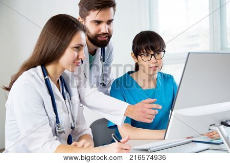 Group of doctors in the clinic discuss the diagnos of the patient