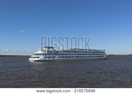 Goritsy, District of Kirillov, Vologda region, Russia - August 10, 2015: Cruise ship Maxim Litvinov goes according the Sheksna River in Kirillov district, Vologda region