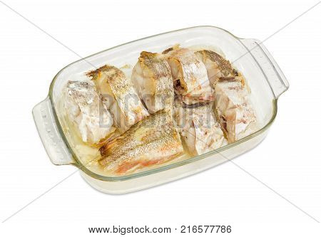 Rectangular glass casserole pan with several baked pieces of the red cod on a white background