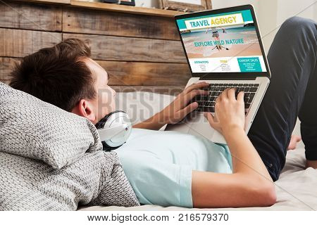 Man using an on line travel agency to book a travel destination.