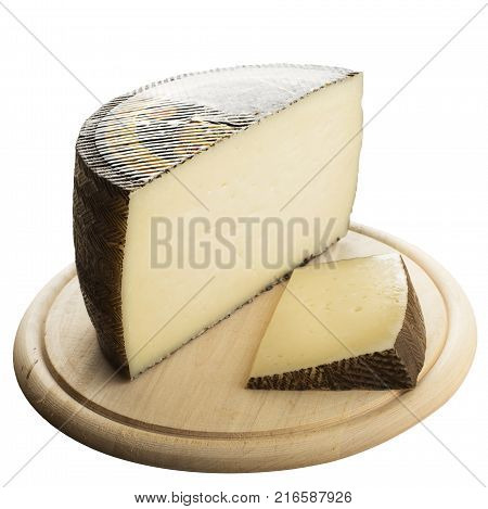 Monchego indented cow cheese served on a wooden plate - isolated