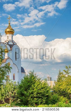 Part of Russian Orthodox church with golden domes on sunny day