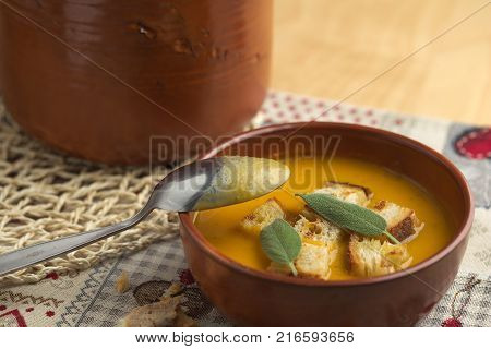 Pumpkin soup and leeks, with sage leaves.