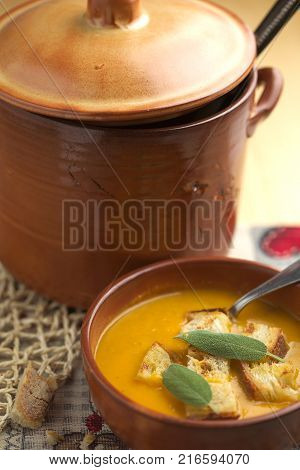 Pumpkin soup and leeks, with sage leaves.
