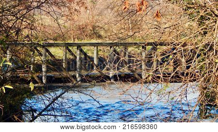 Beautiful wooden bridge view on blue water in autumn