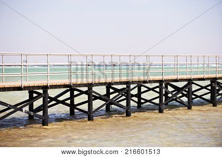 Long wooden jetty on the Red Sea. Pontoon jetty. Egypt.