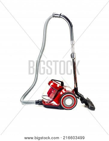 Household cleaning tools and devices. A modern, electric, new, red vacuum cleaner on a white background close-up