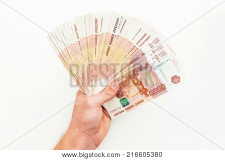 Russian money, banknotes of 5000 rubles in man hand on white background. Flat lay.