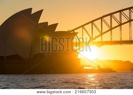 Sydney Australia - July 03 2016: Sydney Opera House And Sydney Harbour Bridge At Sunset With Sun Fla