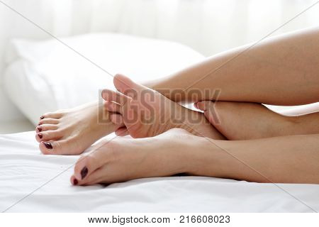 LGBT Lesbian couple legs lying on white bed homosexual lesbian couple moment concept lifestyle