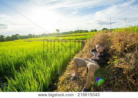 PHOP PHRATAK/THAILAND - September 20:An unidentified child Sleeping in rice fields on September 202017 in PHOP PHRATAK/THAILAND.