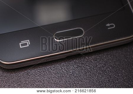 Black smartphone on a black matte background