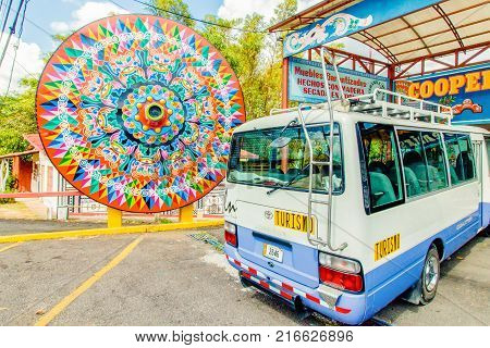 Costa Rica January 2015 in this period the organized tours stop in the factories of wooden objects to show tourists the colorful wooden farm carts. This is a wheel entirely painted by hand