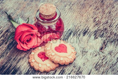 Biscuits with hearts and love elixir. Valentine's Day. Set for lovers. Sweet poison. Philtre in round bottle.