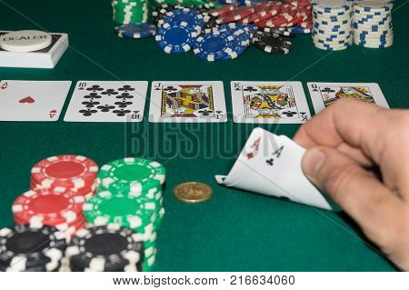A close up image of stacked poker chips and a royal flush. A textured background.Copy paste place