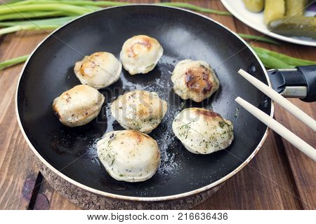 fried dumplings with meat in a frying pan close-up