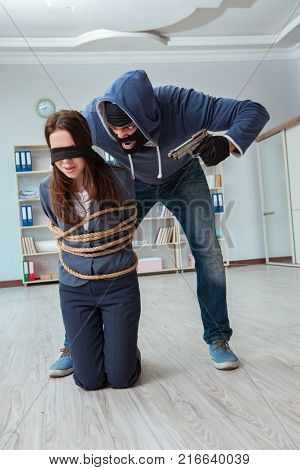 Criminal taking businesswoman as hostage in office