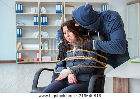 Criminal taking businesswoman as hostage in office
