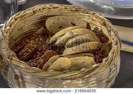 Bread in basket. Slices roll white bread and whole grain bread in the basket served on the table