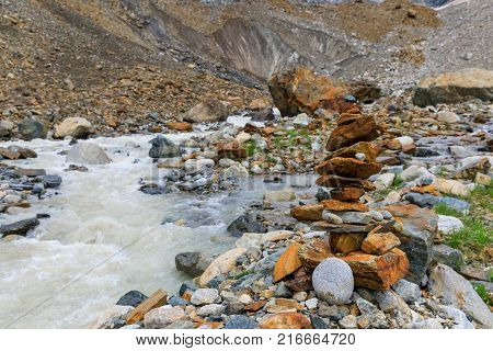 pyramids of stones in the valley river near Chalaadi glacier in Caucasus mountains in summer in Georgia