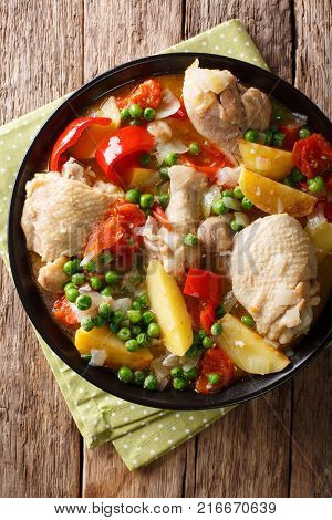 Pieces Of Chicken Stew With Potatoes, Peppers, Tomatoes, Peas And Onions Close-up. Vertical Top View