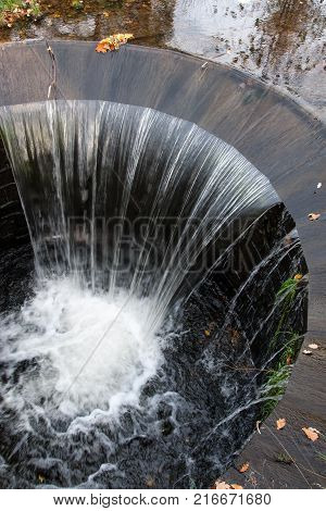 Artificial waterfall in Radun Castle Park in autumn, Czech Republic