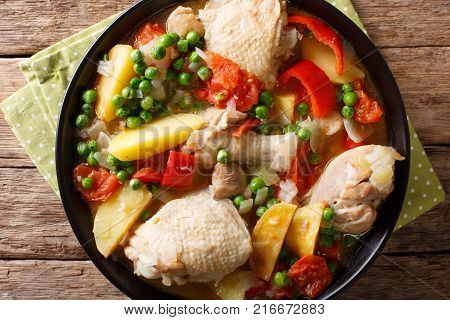 Pieces Of Chicken Stew With Potatoes, Peppers, Tomatoes, Peas And Onions Close-up. Vertical Top View