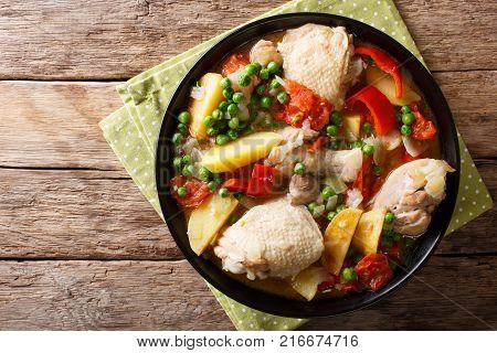 Pieces Of Chicken Stew With Potatoes, Peppers, Tomatoes, Peas And Onions Close-up. Vertical Top View