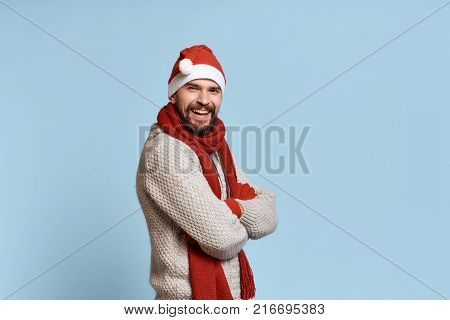 man in a Christmas hat on a light blue background, free space for copying.