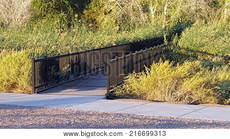 A footbridge leading to a path in the Wetlands