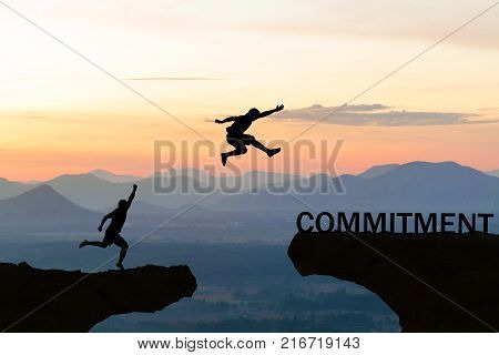 Men jump over silhouette failure commitment to success